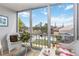 Enclosed lanai with large windows offering views of the lush landscaping and beautiful sky at 649 S Tamiami Trl # 210, Venice, FL 34285