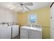 Functional laundry room with washer and dryer hookups, ample space, and a window allowing natural light at 649 S Tamiami Trl # 210, Venice, FL 34285