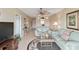 Bright living room featuring tile floors, ceiling fan, and comfortable seating at 649 S Tamiami Trl # 210, Venice, FL 34285