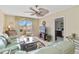 Inviting living room features tile floors, ceiling fan, and sliding glass doors to balcony at 649 S Tamiami Trl # 210, Venice, FL 34285