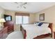 Comfortable main bedroom features neutral walls, plush carpet, ceiling fan, and a large window at 649 S Tamiami Trl # 210, Venice, FL 34285