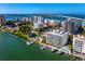 Aerial view of the building, pool, and boat docks in a beautiful waterfront community setting at 650 Golden Gate Pt # 403, Sarasota, FL 34236