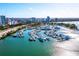 Aerial view of yacht harbor with boat slips, waterways and a city skyline in the background at 650 Golden Gate Pt # 403, Sarasota, FL 34236