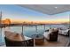 Outdoor balcony seating area with marina and city views, featuring plush seating and a small center table at 650 Golden Gate Pt # 403, Sarasota, FL 34236