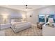 Comfortable bedroom with a plush bed, soft lighting, and a view of the city at 650 Golden Gate Pt # 403, Sarasota, FL 34236