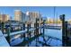 Boat dock in a marina with modern buildings in the background, and a sunny day at 650 Golden Gate Pt # 403, Sarasota, FL 34236