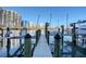 Wooden dock with cityscape views and boat lift in a marina setting at 650 Golden Gate Pt # 403, Sarasota, FL 34236