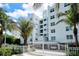 Harbor View condos featuring a gated entrance, lush landscaping, and tropical surroundings at 650 Golden Gate Pt # 403, Sarasota, FL 34236