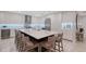 Elegant kitchen with an expansive island, seating, and wine storage at 650 Golden Gate Pt # 403, Sarasota, FL 34236