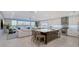 Modern open-concept kitchen with an island and waterfront views from the living room at 650 Golden Gate Pt # 403, Sarasota, FL 34236
