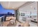 Spacious living area with a combined indoor-outdoor space, balcony, modern kitchen, and comfortable seating at 650 Golden Gate Pt # 403, Sarasota, FL 34236