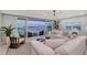 Bright living room featuring plush seating, modern decor, and marina views at 650 Golden Gate Pt # 403, Sarasota, FL 34236