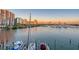 Picturesque view of the marina with boats docked and a stunning city skyline in the background at 650 Golden Gate Pt # 403, Sarasota, FL 34236
