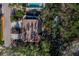 An aerial view shows the home, its landscaping, a canal with a boat, and a deck at 650 Penfield St, Longboat Key, FL 34228