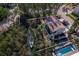 Aerial view of home, canal, boat, and pool, surrounded by palms and other Florida greenery at 650 Penfield St, Longboat Key, FL 34228