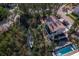 An aerial view shows the home, its landscaping, a canal with a boat, and a pool at 650 Penfield St, Longboat Key, FL 34228