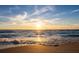 Sunset view on a tranquil ocean with golden light reflecting on the sand and waves at 650 Penfield St, Longboat Key, FL 34228