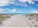 Beautiful beach scene with white sand, ocean view, umbrellas and lounge chairs at 650 Penfield St, Longboat Key, FL 34228