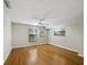 The bright bedroom features hardwood floors, a ceiling fan, and two windows at 650 Penfield St, Longboat Key, FL 34228