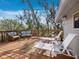 Inviting wood deck featuring wicker furniture and serene views, ideal for relaxing outdoors at 650 Penfield St, Longboat Key, FL 34228