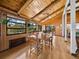 The dining room features a beautiful wooden ceiling, hardwood floors and large windows that flood the room with natural light at 650 Penfield St, Longboat Key, FL 34228