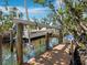 A boat on a boat lift on the canal behind the home has easy access to the open water from the private dock at 650 Penfield St, Longboat Key, FL 34228