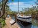 A beautiful sailboat is moored at the private dock offering convenient access to waterfront activities at 650 Penfield St, Longboat Key, FL 34228
