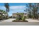 Inviting exterior view of stilted home with covered parking and attractive landscaping and plenty of room for parking at 650 Penfield St, Longboat Key, FL 34228