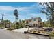 Beautiful home with a sandy driveway and well-manicured landscaping with a red front door and covered parking at 650 Penfield St, Longboat Key, FL 34228