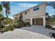 Charming coastal home with a raised foundation, ground-level parking and wooden stairs leading to the entrance at 650 Penfield St, Longboat Key, FL 34228