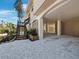 Close up exterior view of home, showing raised foundation with wood accents and tropical foliage surrounding at 650 Penfield St, Longboat Key, FL 34228
