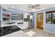 Bright kitchen with stainless steel appliances, white cabinetry, and a view to the outside at 650 Penfield St, Longboat Key, FL 34228