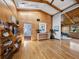 Spacious living room boasts wood-paneled walls, hardwood floors, and a large skylight providing ample natural light at 650 Penfield St, Longboat Key, FL 34228