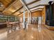 Open-concept room featuring beautiful wood ceilings, hardwood floors, and a breakfast bar with pass through window at 650 Penfield St, Longboat Key, FL 34228