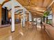 Spacious open concept living space with a wood burning fireplace, hardwood floors, and wood-paneled walls at 650 Penfield St, Longboat Key, FL 34228