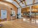 Open-concept room featuring beautiful wood ceilings, hardwood floors, and natural light from large windows at 650 Penfield St, Longboat Key, FL 34228