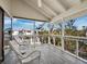 The screened porch offers a serene spot with cushioned seating and outdoor views at 650 Penfield St, Longboat Key, FL 34228