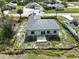 An aerial view showing a gray metal roof, an open garage, and the bare land surrounding the property at 6970 Beckwith Ave, North Port, FL 34291