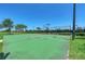 Outdoor basketball court surrounded by lush landscaping and a tall fence at 7019 River Hammock Dr # 104, Bradenton, FL 34212