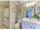 Clean bathroom features a shower with a curtain, a white vanity, and tile flooring at 7019 River Hammock Dr # 104, Bradenton, FL 34212