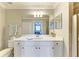 Well-lit bathroom with a white vanity, large mirror, and a separate toilet area at 7019 River Hammock Dr # 104, Bradenton, FL 34212