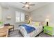 Inviting bedroom with colorful accents, a ceiling fan, and plantation shutters at 7019 River Hammock Dr # 104, Bradenton, FL 34212