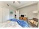 Comfortable guest bedroom with a ceiling fan, wood-look floors, and ample natural light at 7019 River Hammock Dr # 104, Bradenton, FL 34212