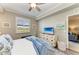Bright bedroom featuring a ceiling fan, plantation shutters, and an accent chest at 7019 River Hammock Dr # 104, Bradenton, FL 34212