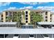 Inviting condo building featuring lush landscaping, covered parking, and a welcoming entrance at 7019 River Hammock Dr # 104, Bradenton, FL 34212