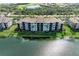 Aerial view of a building with a lake view in a lush, green community at 7019 River Hammock Dr # 104, Bradenton, FL 34212