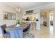 Dining area features a round wood table with blue chairs and view to kitchen at 7019 River Hammock Dr # 104, Bradenton, FL 34212