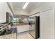 Modern kitchen with stainless steel appliances, granite countertops, and ample cabinet space at 7019 River Hammock Dr # 104, Bradenton, FL 34212