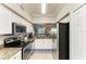 Well-equipped kitchen with white cabinets and stainless steel appliances at 7019 River Hammock Dr # 104, Bradenton, FL 34212