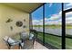 Relaxing screened lanai with seating and a stunning water view at 7019 River Hammock Dr # 104, Bradenton, FL 34212